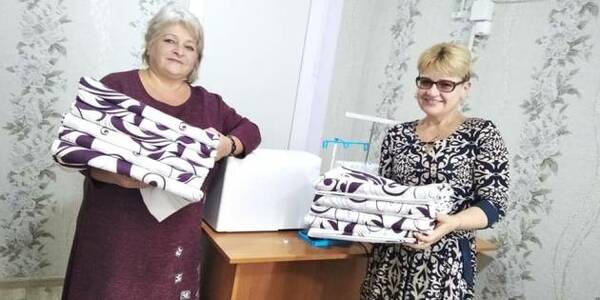 Volunteers from a municipality in the Mykolaiv oblast sew bed linen and pillows for the hospital
